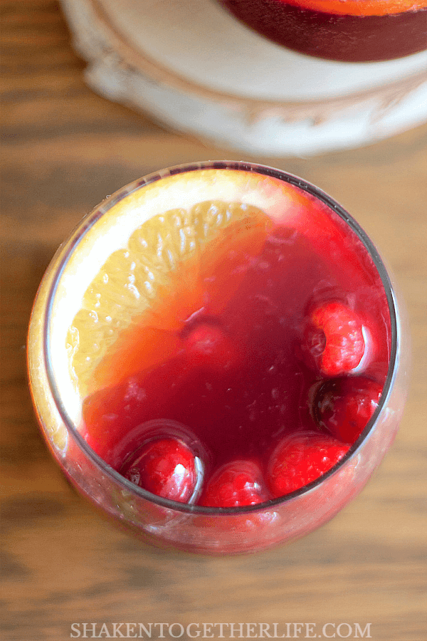 Garnish each glass of Sparkling Sangria Punch with an orange slice and bright red berries!