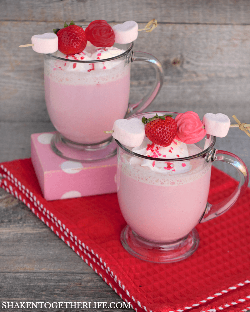 Curl up by the fireplace with a snug blanket with these cute strawberry Cupid hot cocoas and watch some movies. Click here for the recipe. - www.theballeronabudget.com