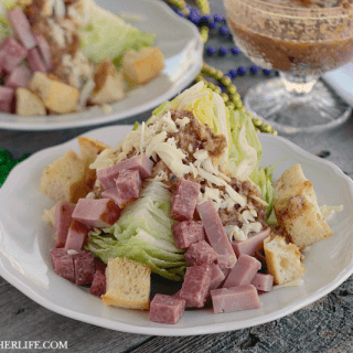 Muffaletta Wedge Salad - this hearty side salad has all of the flavors of a traditional muffaletta sandwich over a crisp iceberg lettuce wedge!
