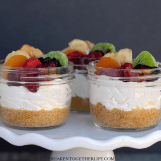 Rainbow Fruit Cheesecakes in a Jar - this is my favorite no bake cheesecake recipe with a homemade graham cracker crust and topped with gorgeous rainbow fruit!
