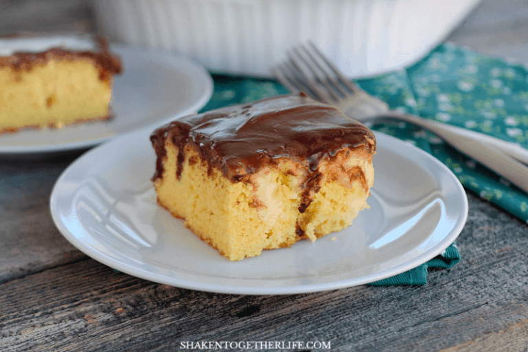 Boston Cream Pie Poke Cake - a tender yellow cake with pockets of vanilla pudding and a smooth chocolate frosting!