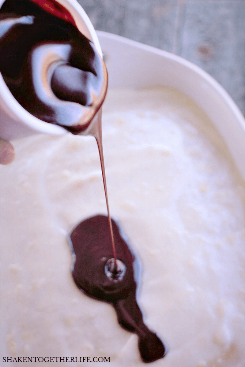 pouring chocolate over Boston Cream Pie Poke Cake batter
