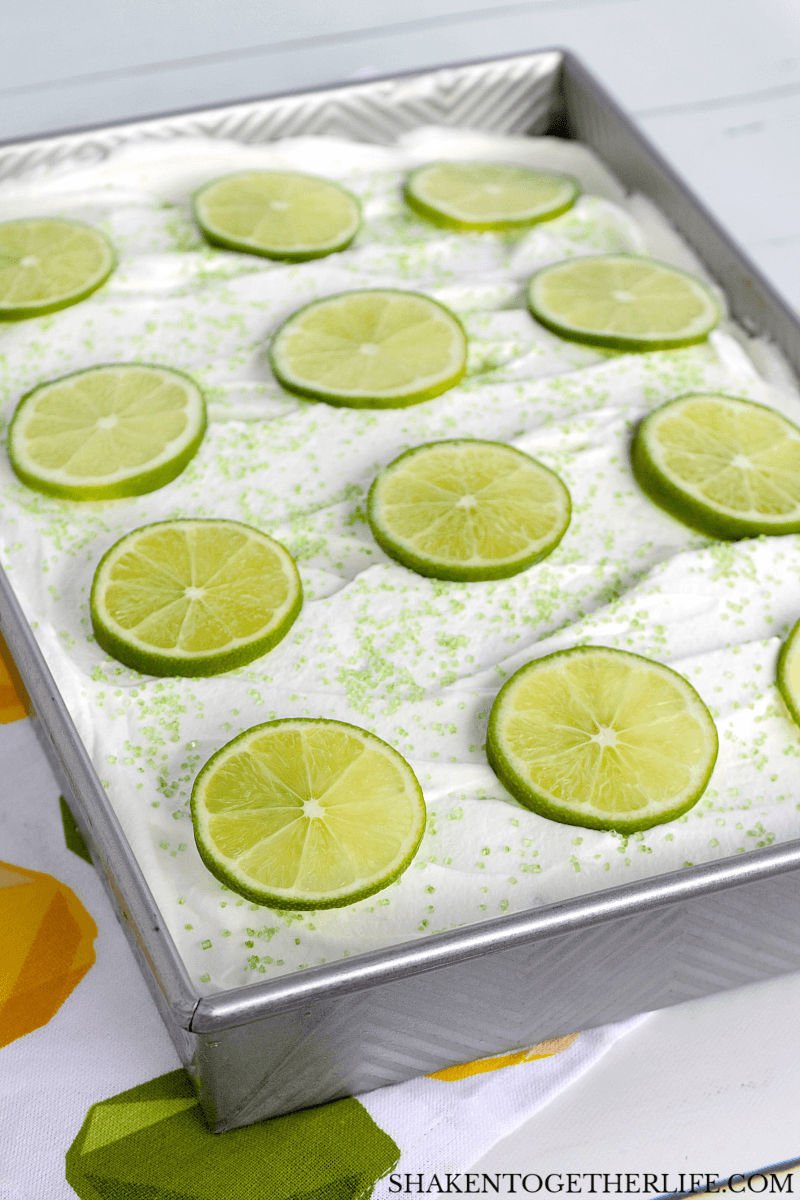 Simple and stunning, this Lime Poke Cake is topped with bright green lime slices!