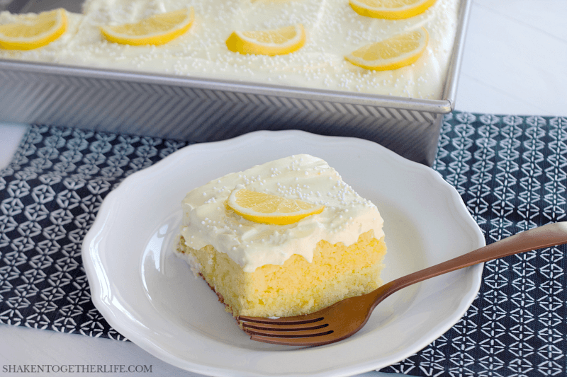 Triple Lemon Poke Cake piece on white plate