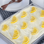 Triple Lemon Poke Cake in a pan on table
