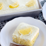 Triple Lemon Poke Cake on white plate