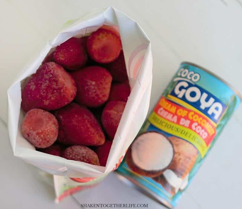 overhead view of frozen strawberries and Goya cream of coconut