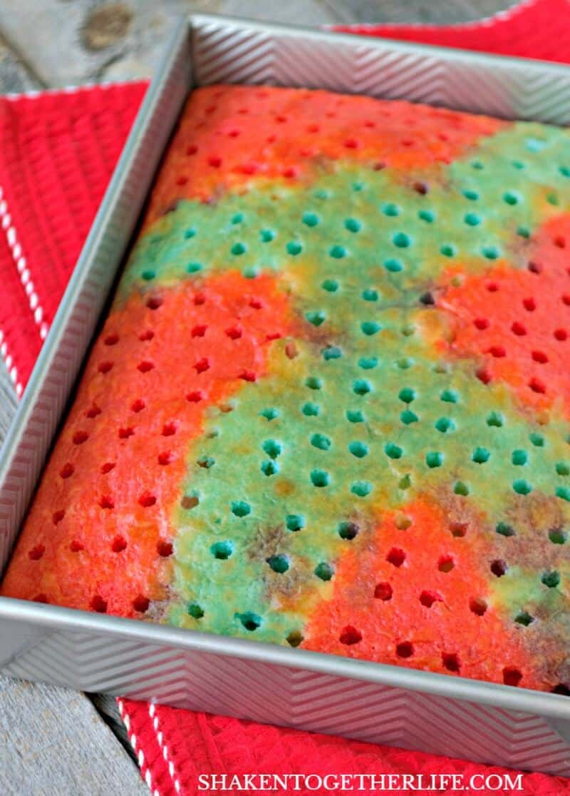 Carefully spoon red Jell-o over a portion of the cake for our Red, White & Blue Poke Cake