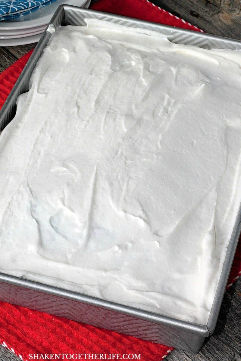 Fluffy whipped topping is a blank canvas just waiting for sprinkles - wait until you see the Red, White & Blue Poke Cake underneath
