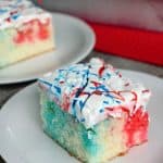 Red, White & Blue Poke Cake! This easy patriotic dessert take a white cake from boring to BOOM with the addition of red and blue Jello! Add swirls of color and sprinkles for an easy, festive 4th of July cake!