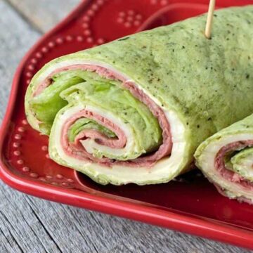 roast beef roll ups on red plate