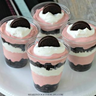 Fluffy red velvet pudding mousse is layered with crushed Oreos and whipped cream in these super easy no bake Oreo Red Velvet Pudding Cups!