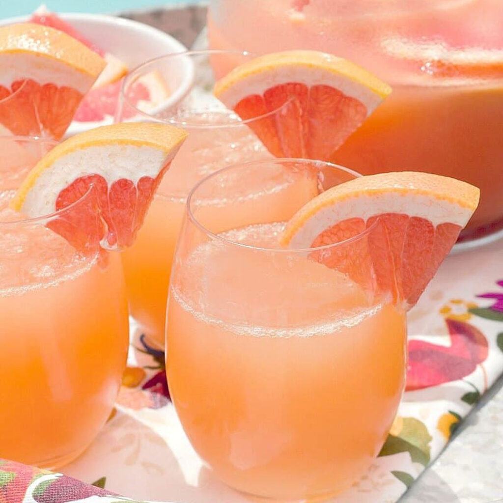 grapefruit mimosas in stemless glasses