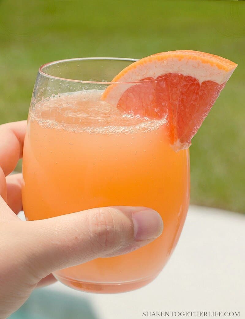 Ruby Red Grapefruit Mimosa with wedge of grapefruit garnish