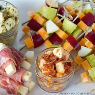 3 EASY Cheesy Appetizers - these simple cheese appetizers start with cheese sticks! Pesto mozzarella bites, prosciutto wrapped pepper jack and fruit & cheese skewers are simple, delicious and perfect for entertaining!