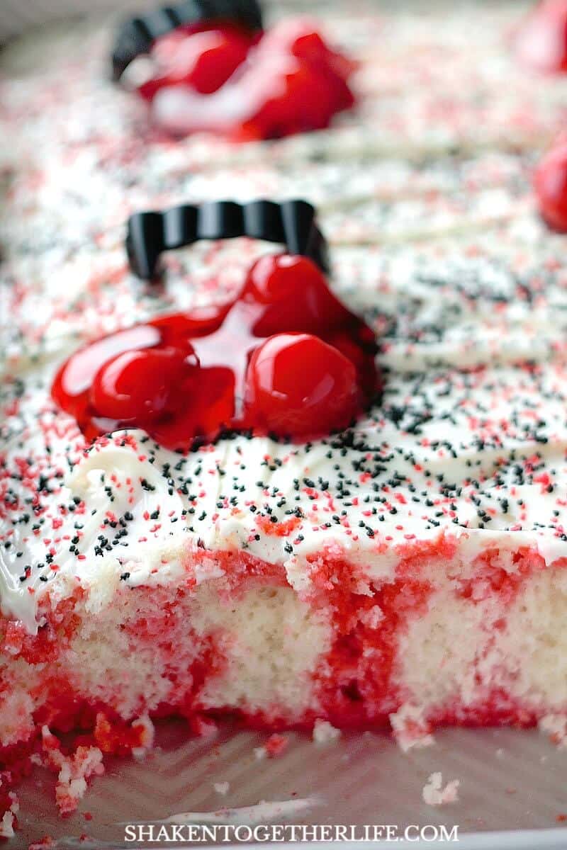 The inside of this Cherry Vanilla Vampire Poke Cake looks like it may have been bitten by a vampire!