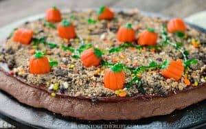 Need an easy Fall or Halloween dessert? This Pumpkin Patch Dessert Pizza is a chocolate-y field of delicious candy pumpkins!