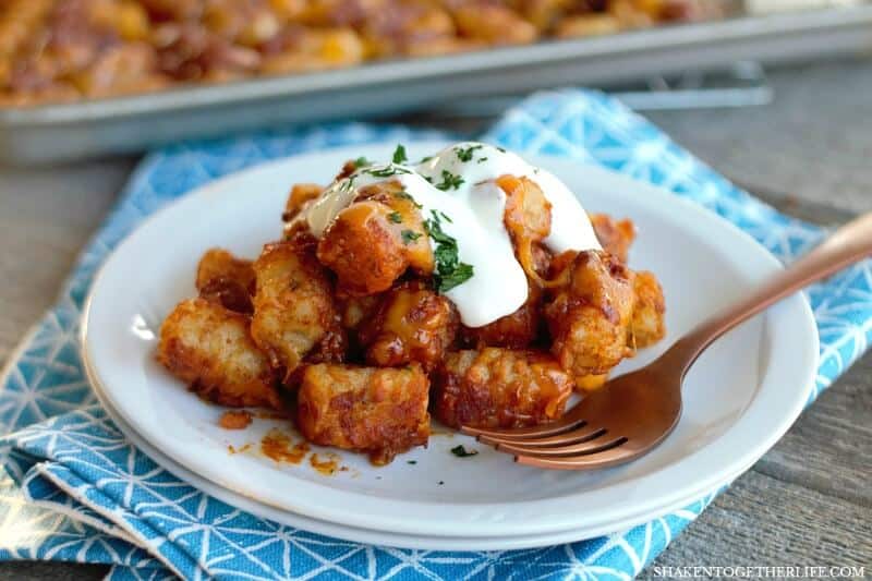 Sheet Pan Chili Cheese Tater Tots on a white plate with a fork