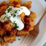 tater tots with chili, melted cheese, and sour cream