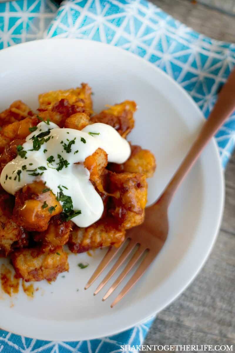 Sheet Pan Chili Cheese Tater Tots on a white plate with a fork