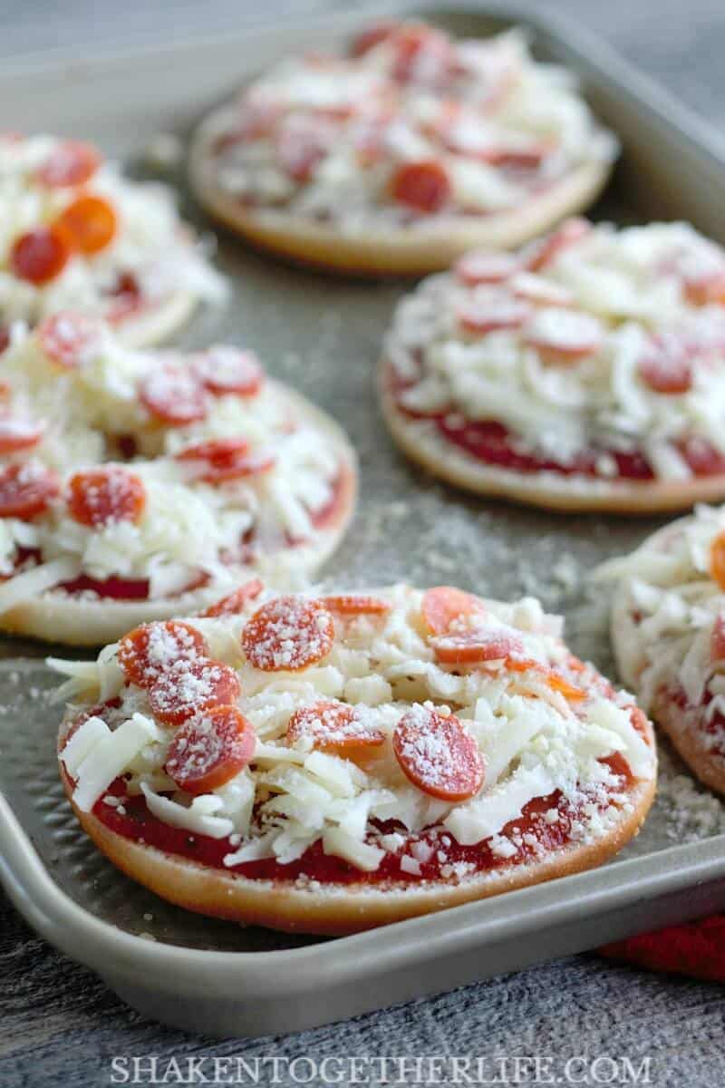 Thin Crust Bagel Pizzas are the ultimate easy dinner or snack idea! Bagel thins are loaded with your favorite pizza toppings then baked until the cheese is bubbly and melted to perfection!