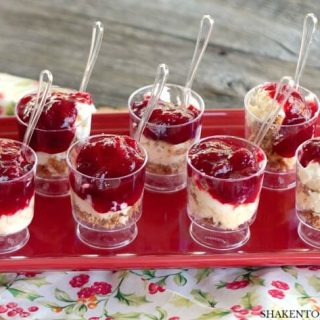 Topped with a homemade orange cranberry sauce, these No-Bake Mini Cranberry Cheesecakes are an easy, impressive no bake holiday dessert!