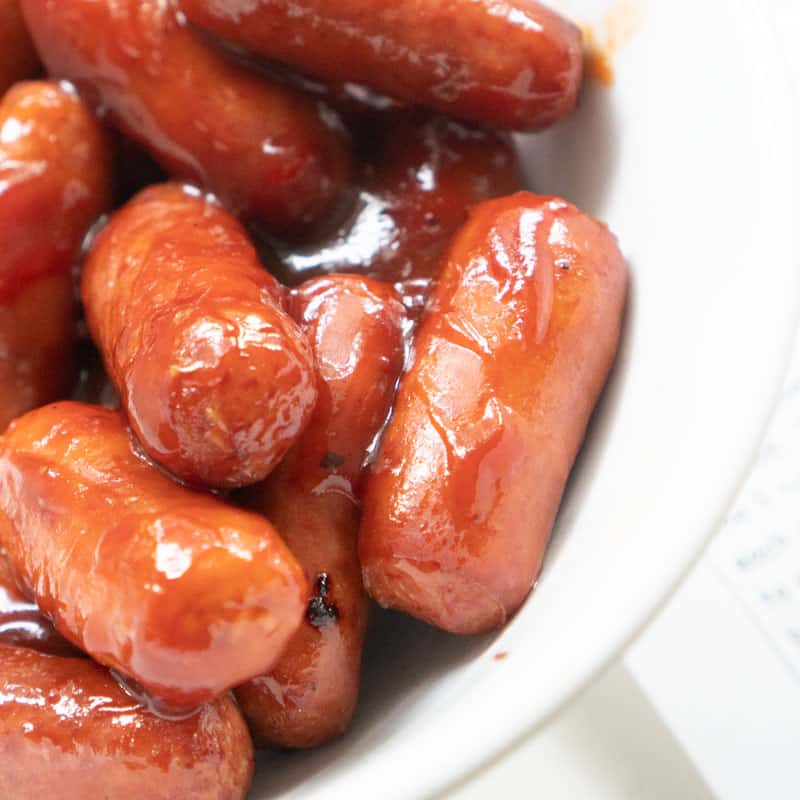 close up of little smokies in white bowl