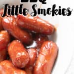 close up of little smokies cocktail sausages in orange barbecue sauce in white bowl
