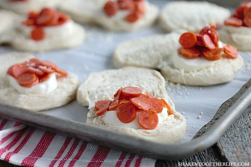 Pizza Stuffed Waffles start with refrigerator biscuits. Open them up and stuff in fresh mozzarella and your favorite pizza toppings. Then, pop them in your waffle maker!