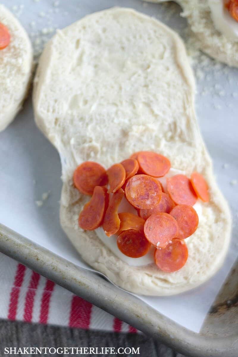 Pizza Stuffed Waffles start with refrigerator biscuits. Open them up and stuff in fresh mozzarella and your favorite pizza toppings. Then, pop them in your waffle maker!