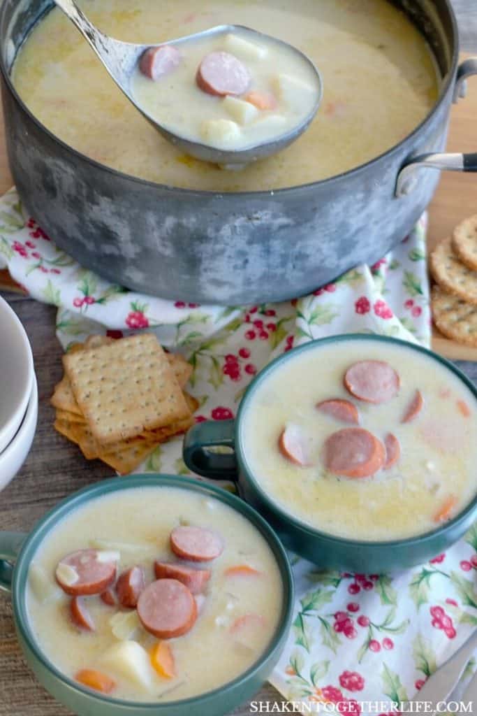 Grandma's Creamy Sausage & Potato Soup in a pot with two bowls of soup nearby