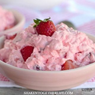 Pink Strawberry Fluff Salad is bursting with bites of bright berries! With only 4 ingredients, this classic dessert salad is perfect for dinner, parties and baby showers!