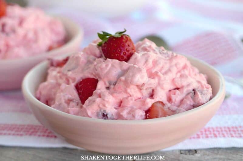 Pink Strawberry Fluff Salad with strawberry on top