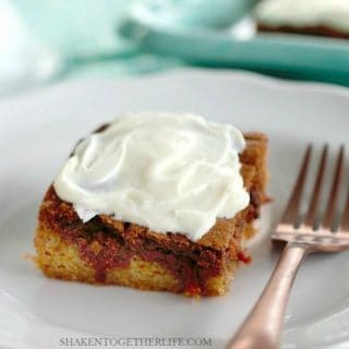 Double Decker Carrot Cake Sugar Cookie Bars with Cream Cheese Frosting! A layer of soft sugar cookie is topped by a layer of carrot cake mix cookies and topped with a layer of tangy cream cheese frosting! This Easter dessert is a knock out!