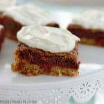 Double Decker Carrot Cake Sugar Cookie Bars with Cream Cheese Frosting! A layer of soft sugar cookie is topped by a layer of carrot cake mix cookie and topped with a layer of tangy cream cheese frosting! This Easter dessert is a knock out!