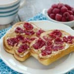 Thick slices of sturdy toasted bread slathered with peanut butter and topped with fresh smashed raspberries makes for a delicious twist on breakfast! Smashed Berry Breakfast Toast is a simple breakfast dish that brightens up breakfast!