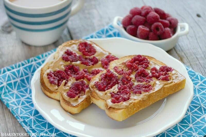 Thick slices of sturdy toasted bread slathered with peanut butter and topped with fresh smashed raspberries makes for a delicious twist on breakfast! Smashed Berry Breakfast Toast is a simple breakfast dish that brightens up breakfast!