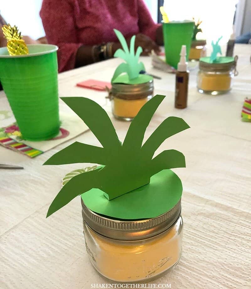 Transform a yellow dollar store candle into a Perky Pineapple Candle with simple paper and twine embellishments - this fun idea is perfect for a Tropical Summer Craft Party