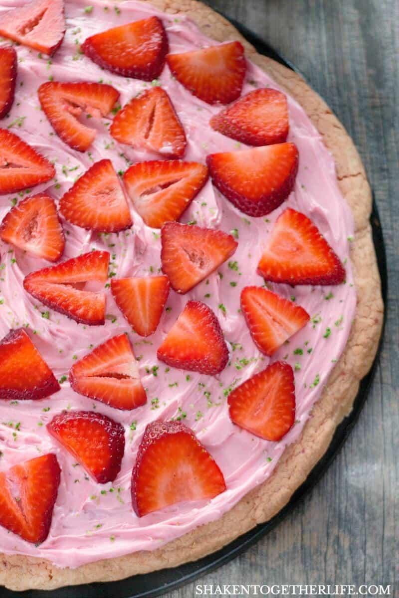 Strawberry Dessert Pizza from a Cake Mix is the perfect easy dessert for a party or potluck! With just a few ingredients that you can keep stocked in your pantry, this strawberry dessert comes together quickly and is a crowd pleaser for sure!