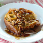 waffle casserole with pecan sauce on white plate with fork