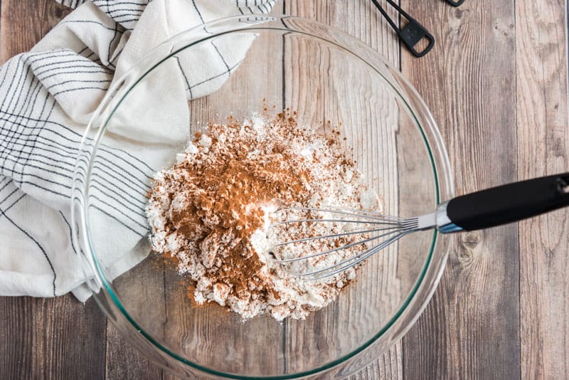 mixing eggnog cookie dough in glass bowl