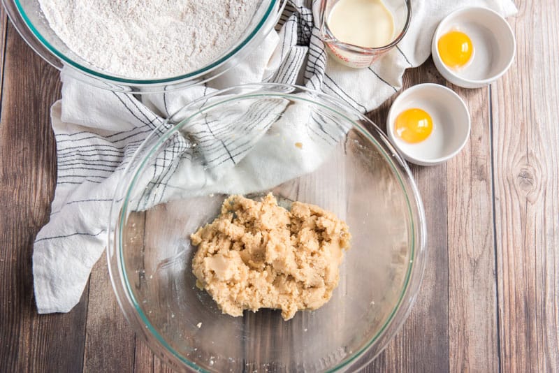 mixing eggnog cookie dough in glass bowl