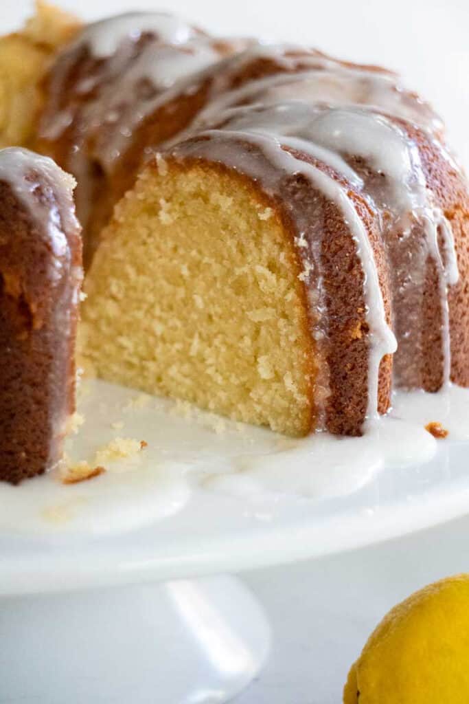 lemon bundt cake on white cake stand