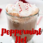 peppermint hot chocolate in glass mug with whipped cream and sprinkles