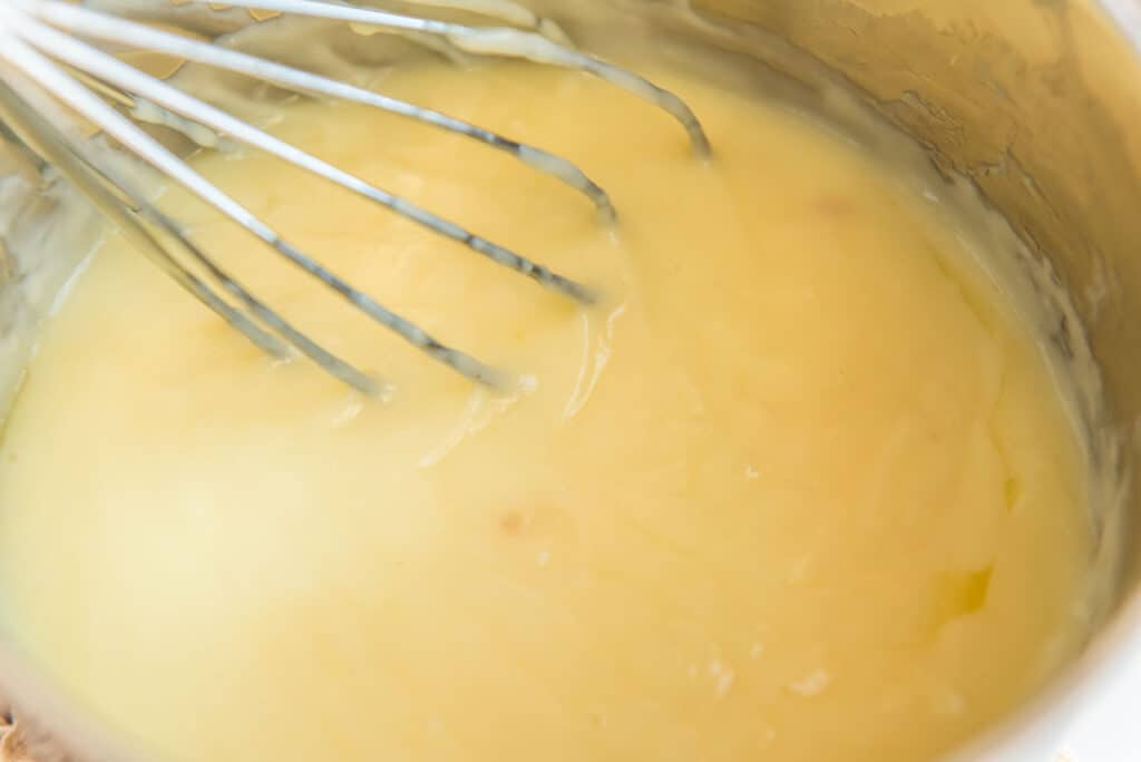 stirring homemade coconut pudding