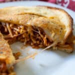 spaghetti sandwich grilled cheese on white plate with red napkin