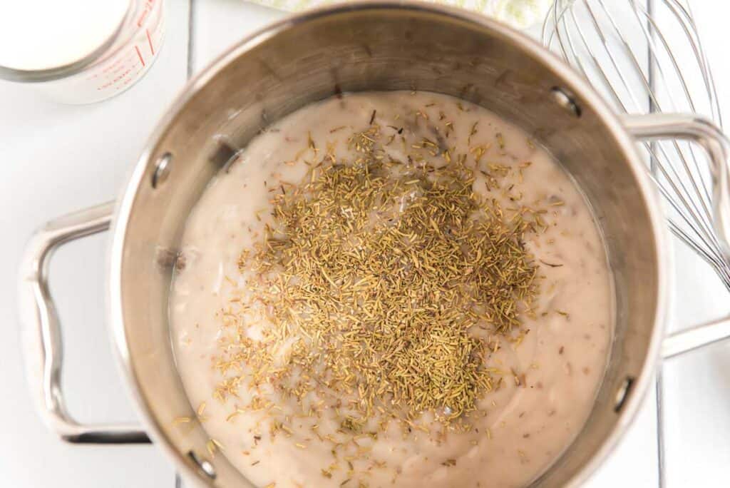 mixing cream of mushroom soup and seasoning in saucepan