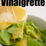 pouring dijon vinaigrette over salad