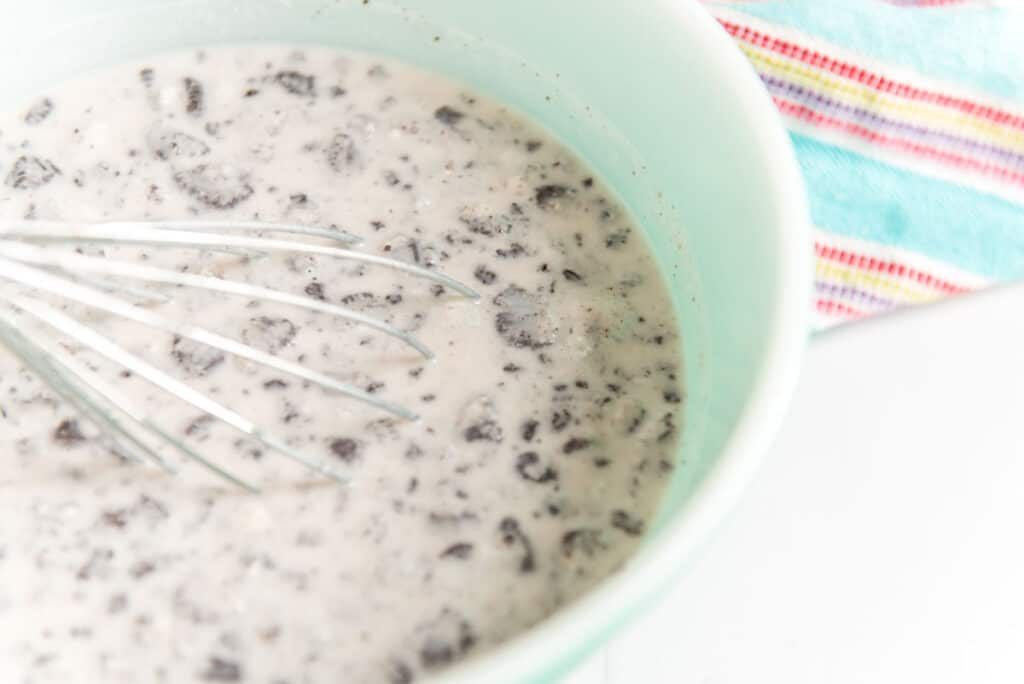 oreo pudding being whisked in bowl