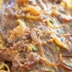 close up of meat over pasta with text reading slow cooker london broil